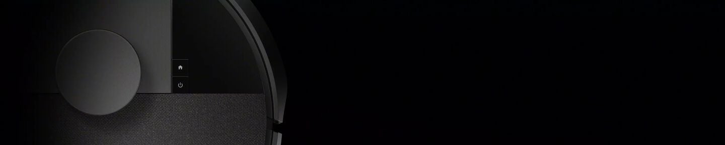 An image of a Roomba robot vacuum against a dramatic black background.